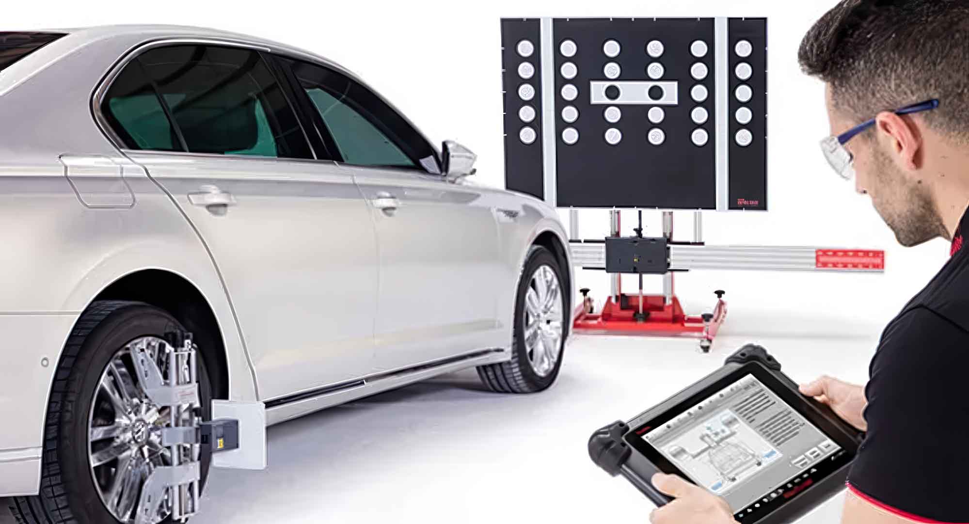 ADAS Calibration and Diagnostic Services - Technician performing scan on silver sedan - Apex Auto Center
