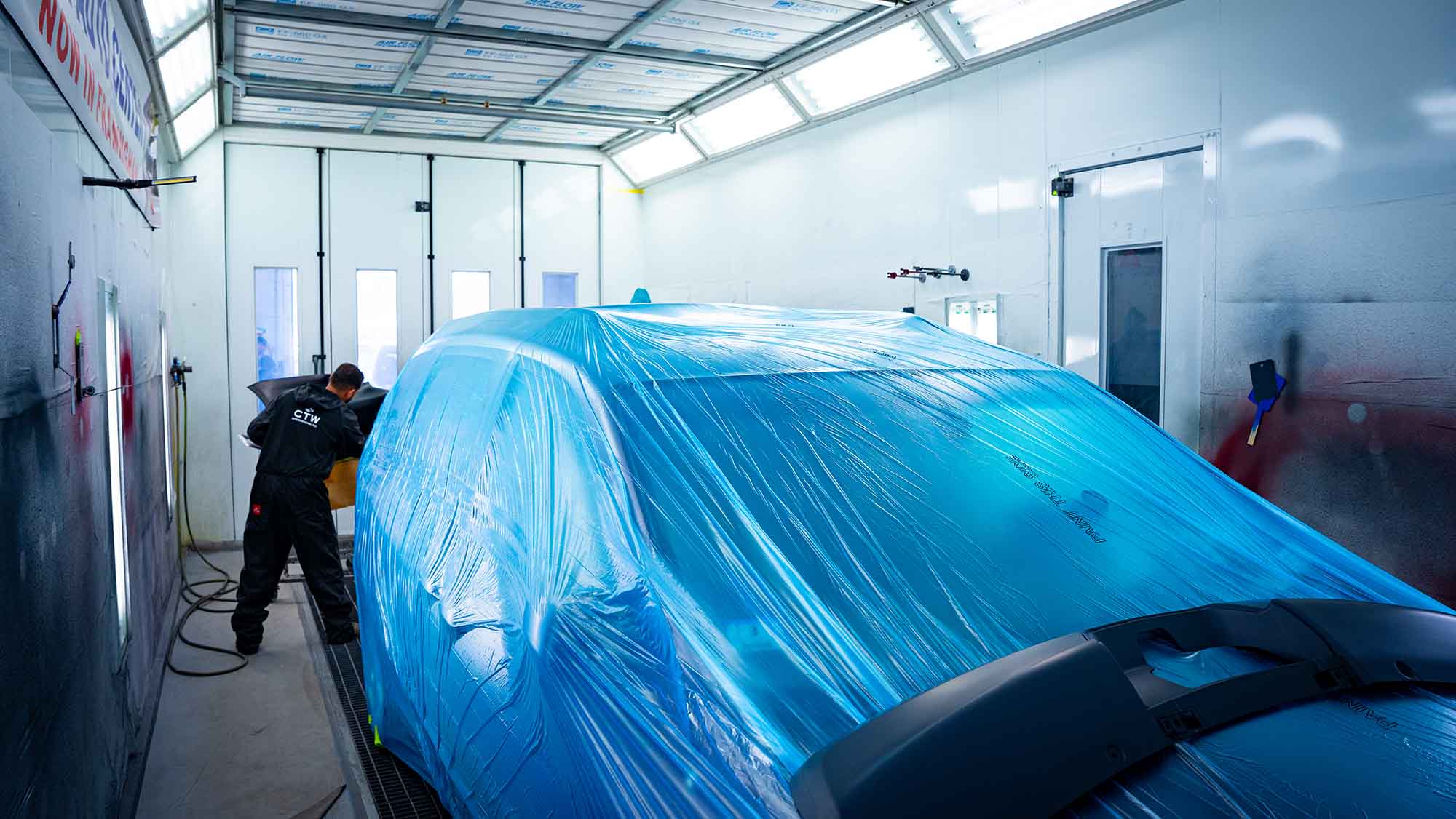 auto body collision repair-60 auto paint repair tech in booth