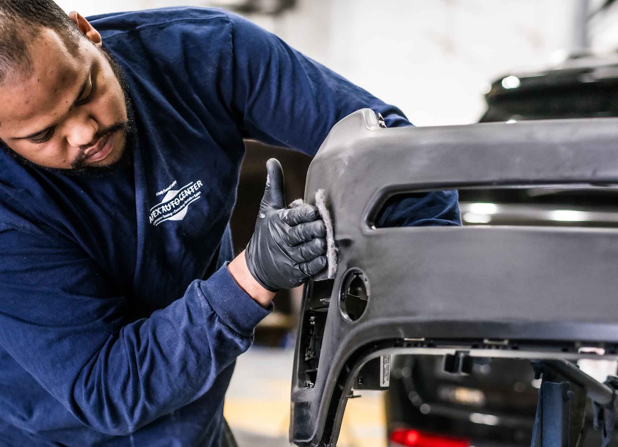 Technician prepping bumper for paint - auto body repair services - apex auto center 