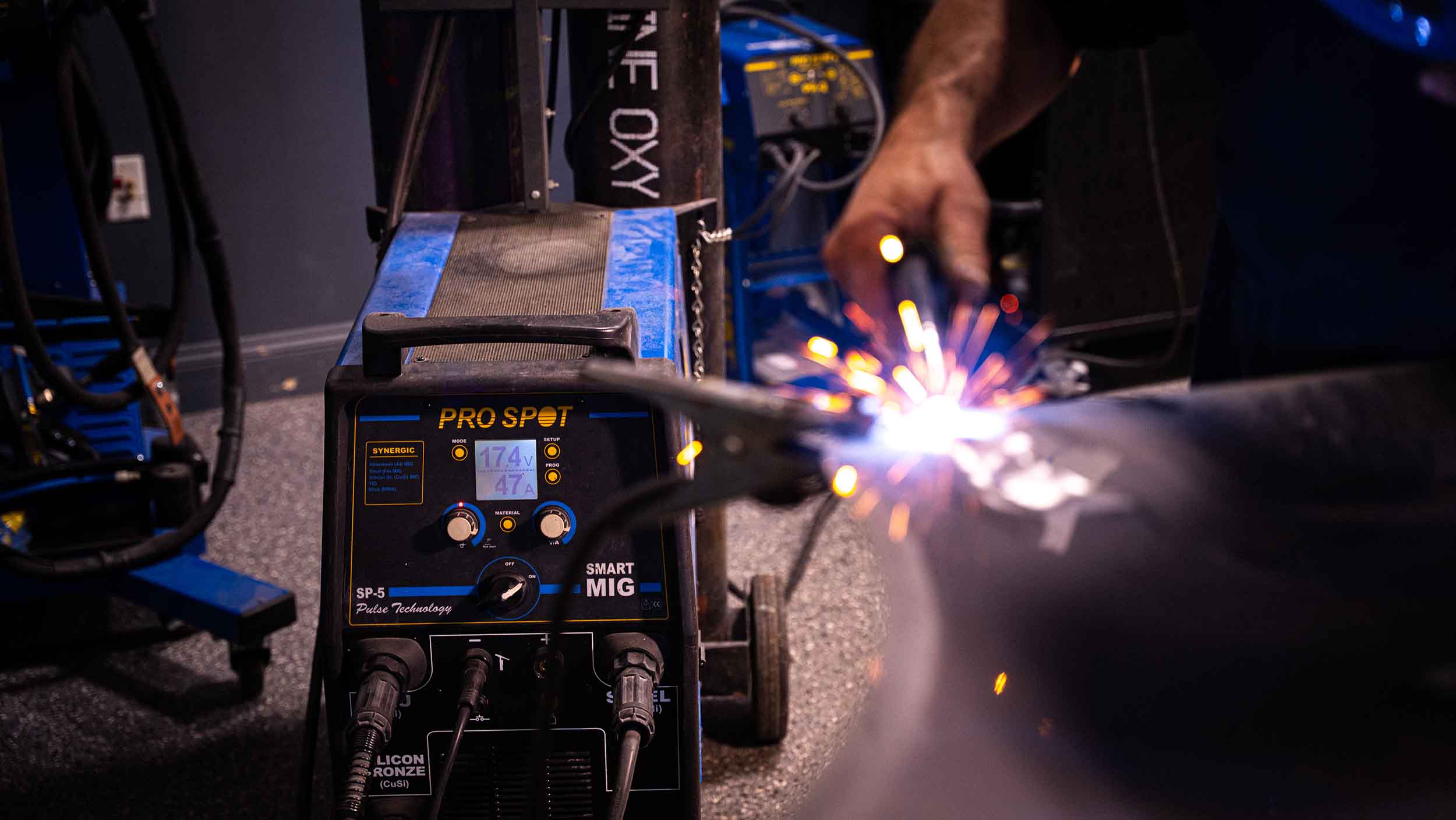 technician using pro spot welder to repair vehicle - auto body repair services - apex auto center 